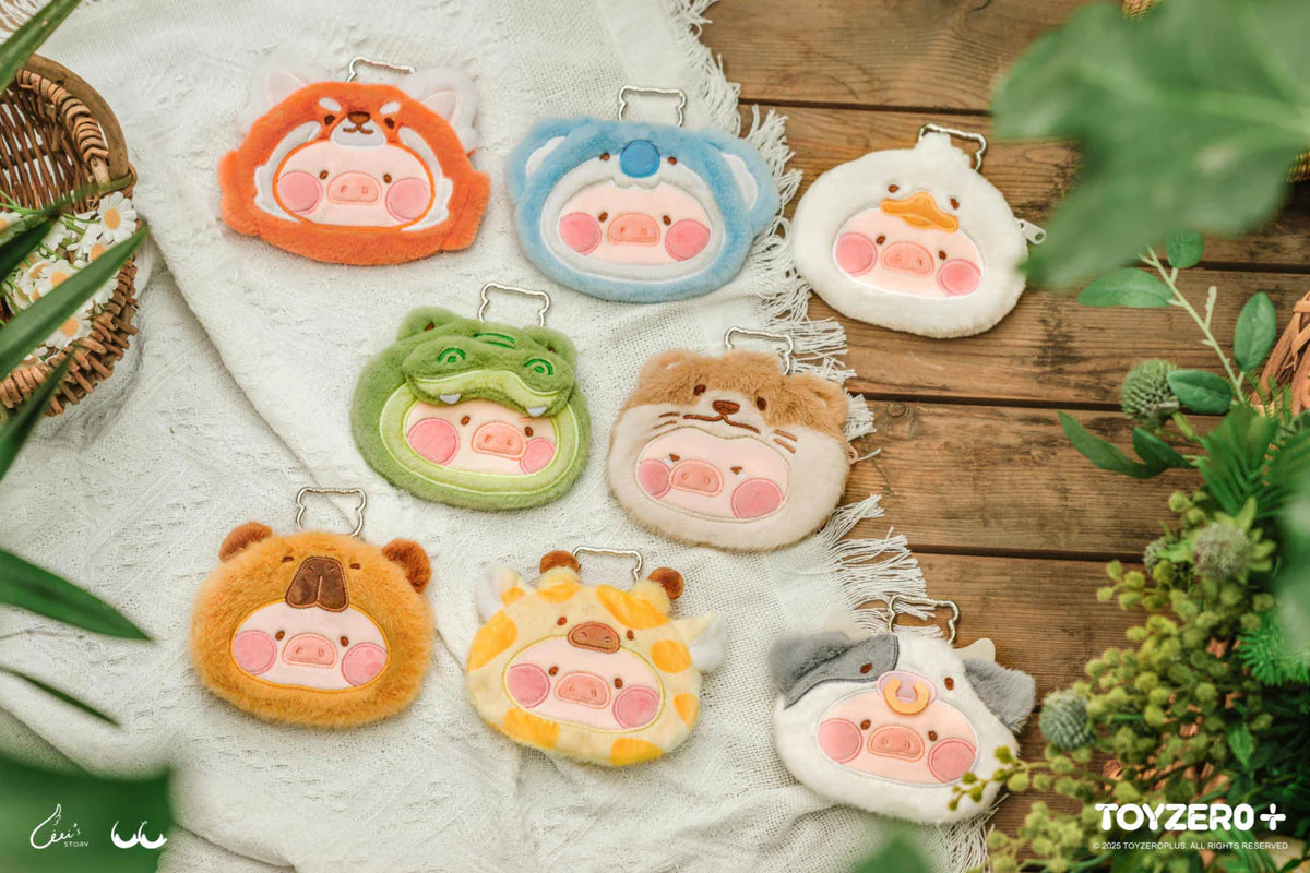 Set of cute Lulu the Piggy Animal Party plush pouch keychains on a wooden surface with plants around